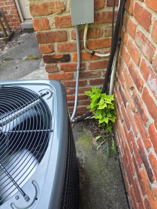 Air-conditioning unit beside a brick home